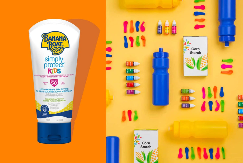 A playful display of a sample Banana Boat® product with balloons and water bottle