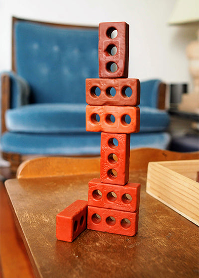 Image of a tower of stacked Guidecraft Little Bricks. 
