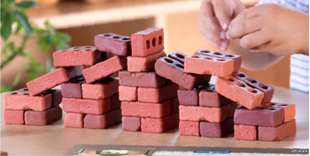 Image of a child building with Guidecraft Little Bricks