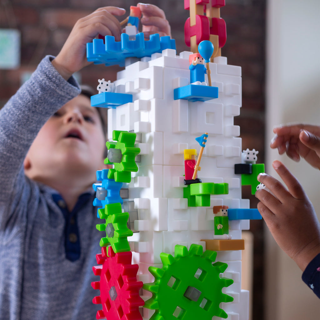 Boy building tower with Tabletop IO STEM Blocks