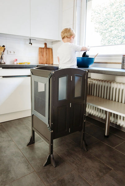 young boy, standing in Martha Stewart Kitchen Helper Toddler Step Stool - Charcoal at kitchen sink, washing dishes