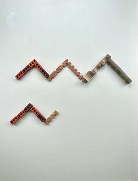 Little Bricks, Tabletop Notch Blocks, and Branch Blocks arranged in patterns during loose parts play