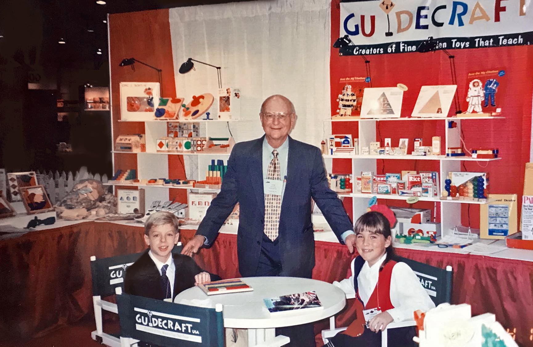 Image of Guidecraft founder, the late Fred Fein, at a tradeshow from many years ago showcasing many of the original Guidecraft products and wooden toys.