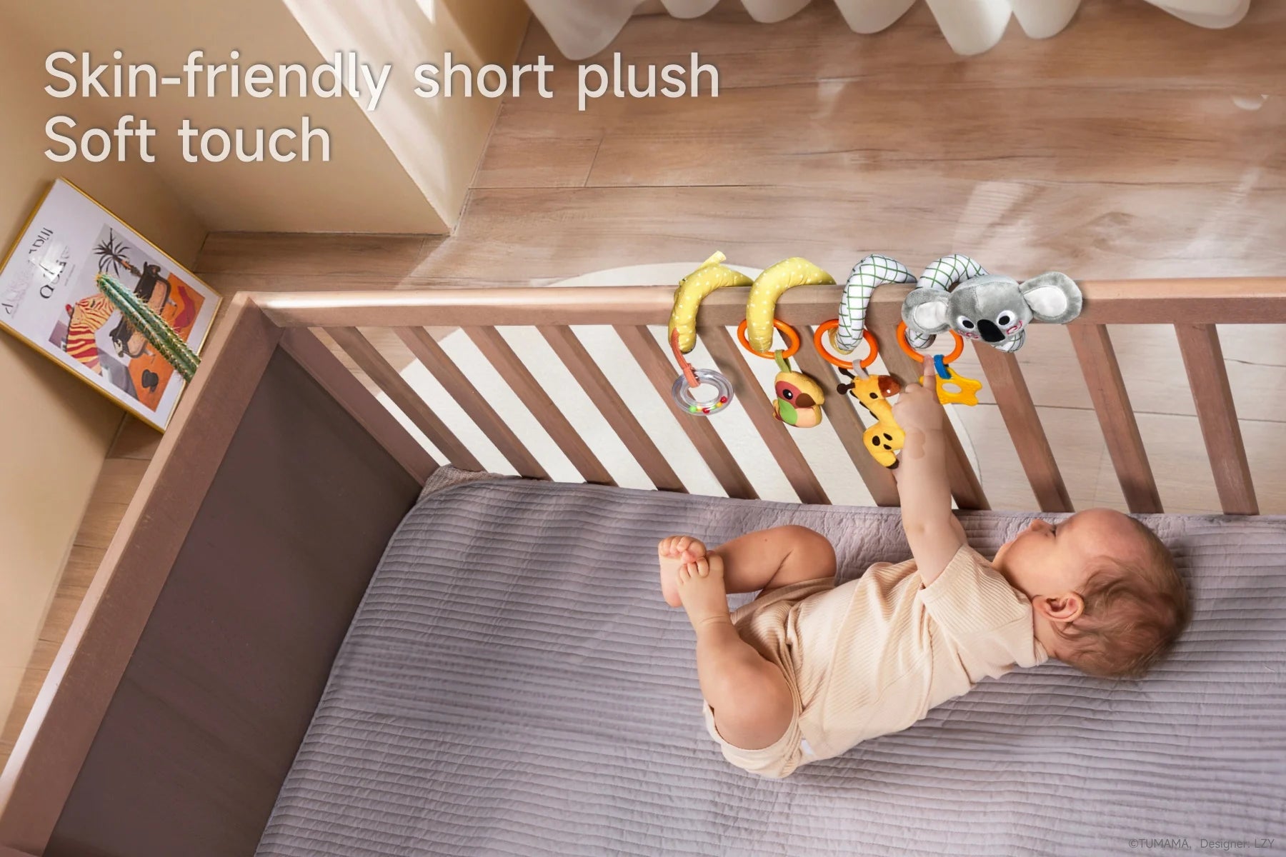 A baby playing with a koala giraffe bird arch baby toy