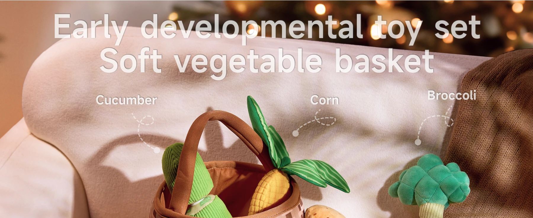 A soft, felted basket filled with friendly, colorful vegetable toys—a cucumber, corn, and broccoli—for early sensory play.