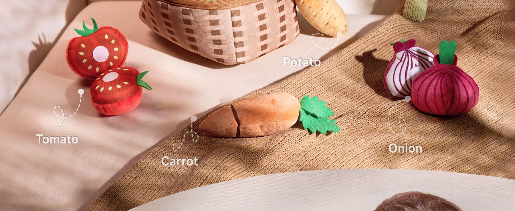 A playful assortment of felted vegetable toys set on a textured fabric surface