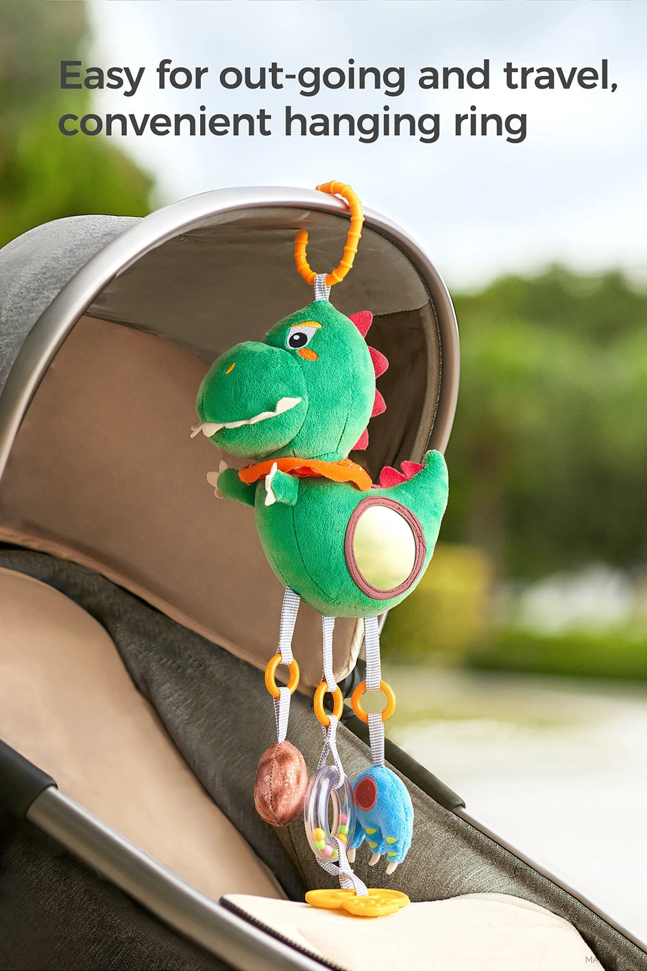 Newborn infant sensory play with dinosaur hanging toy