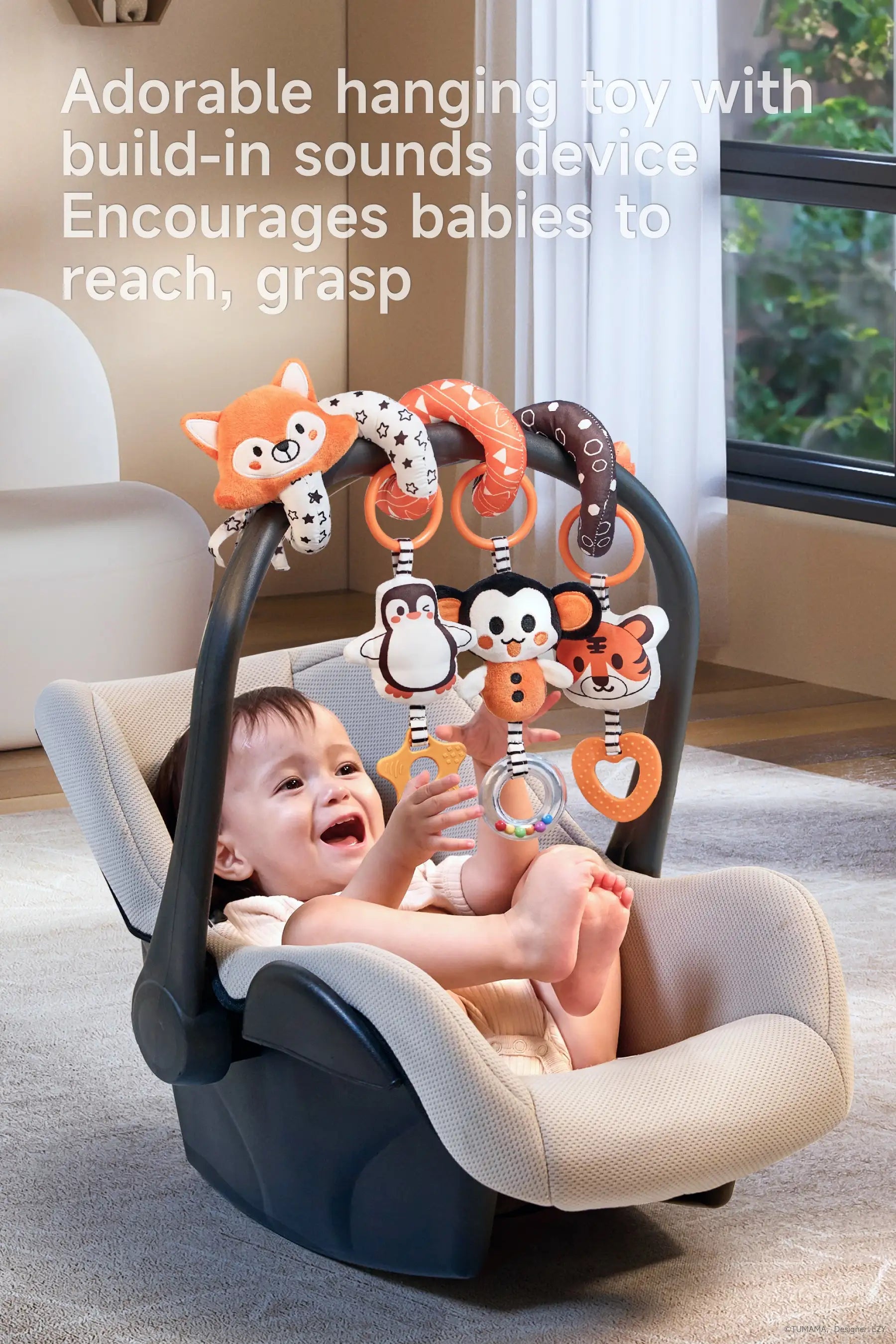 A baby in a car seat with high-contrast animal toys (fox, tiger, penguin) on an arch.