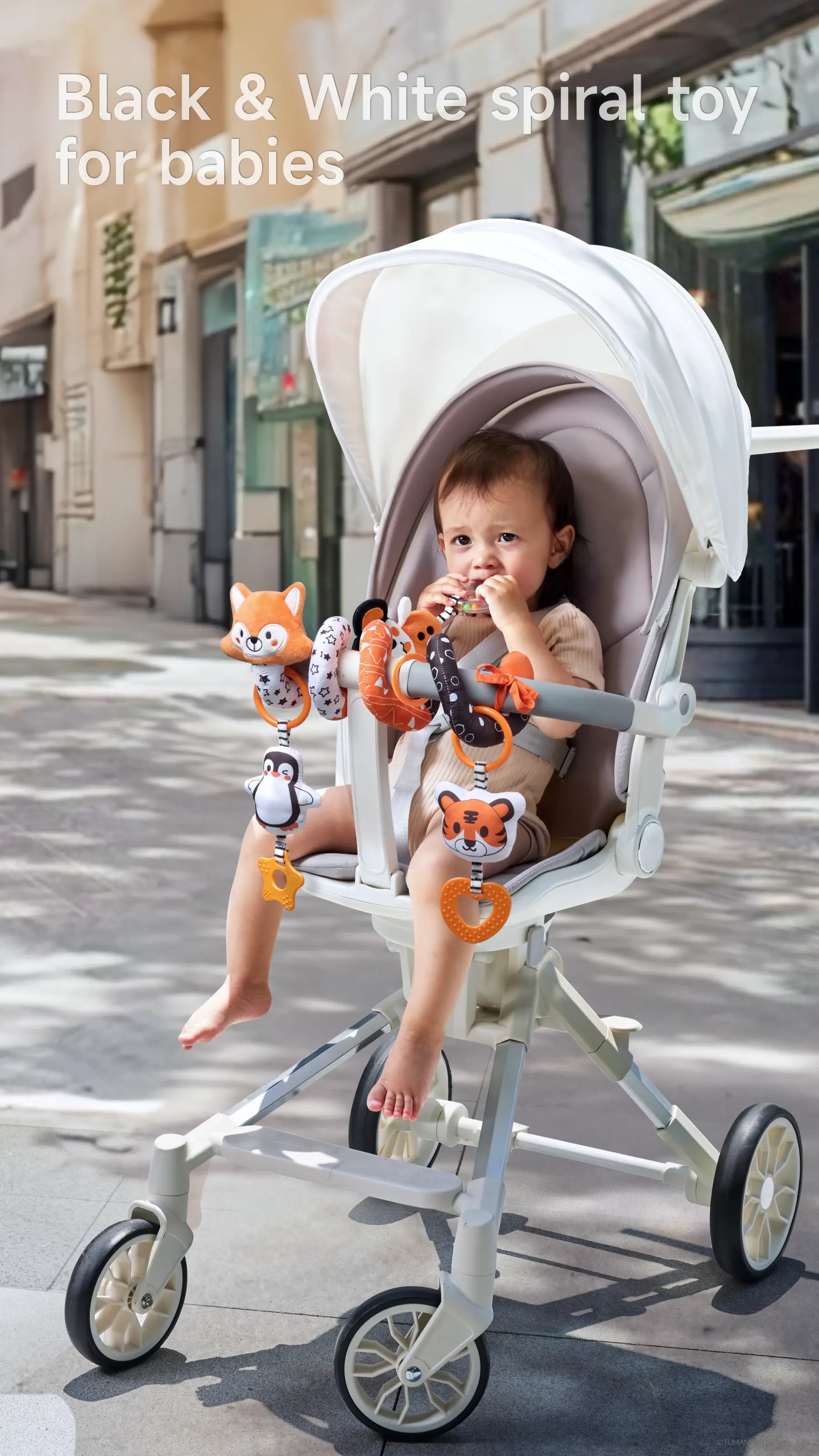 Shows the cute fox spiral toy securely attached to a car seat, perfect for on-the-go babies.