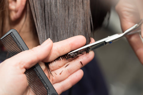 Long female hair being cut