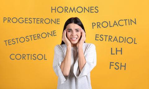 Hormone names in text surrounding a young woman with her head in her hands