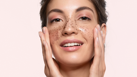 A girl exfoliates her face 