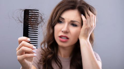 girl uses hair loss treatment