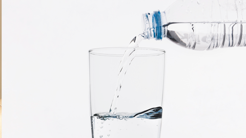 Girl drinks water to maintain her healthy hair 