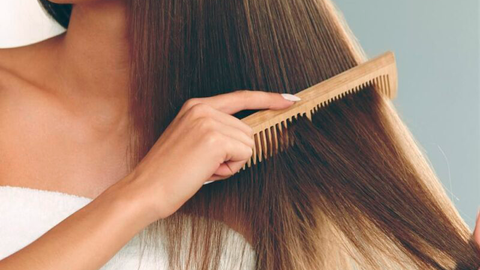 A girl nourishes her dry hair with the best dry hair products 