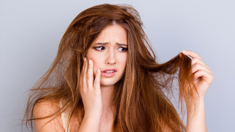 A girl nourishes her dry hair with the best dry hair care products 