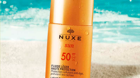 A girl uses Nuxe Light Fluid High Protection SPF 50