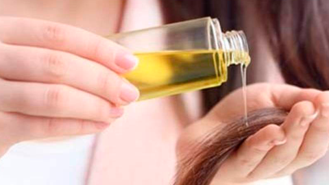 Girl uses hair oils to get healthy hair 