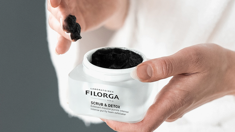 Girl applies body care product Filorga Scrub And Detox