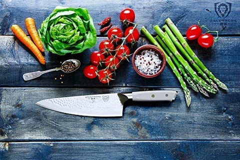 Knife on a blue wooden cutting board along with some veggies