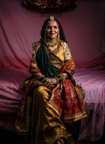 Ashaji , the bride's mother dressed in a beautiful golden lengha made by designer Ayush Kejriwal.