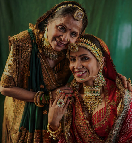 Ashaji , the bride's mother dressed in a beautiful golden lengha made by designer Ayush Kejriwal.