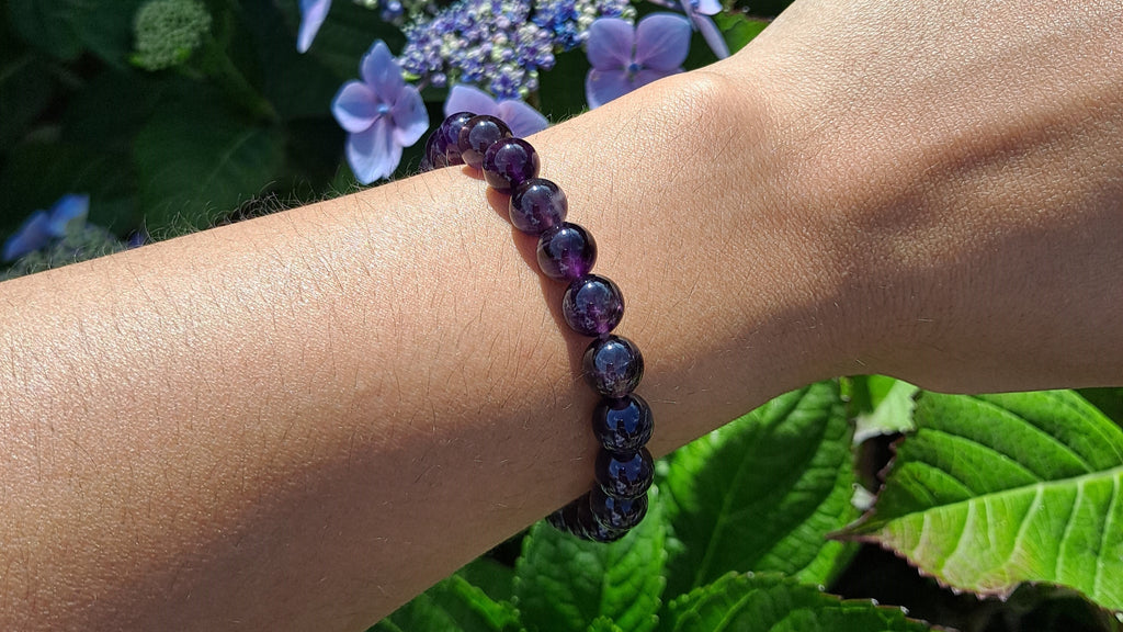 image of an amethyst bracelet made with 8mm beads. this bracelet is available at dumi's crystals