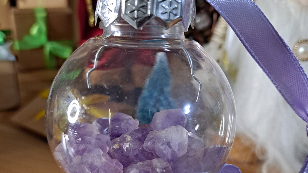 image of a christmas tree bauble filled with amethyst chips. this christmas decoration is available at dumi's crystals
