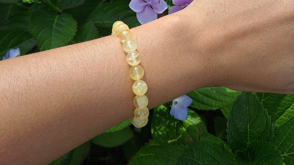 image of a citrine 8mm bead bracelet. this bracelet is available at dumi's crystals