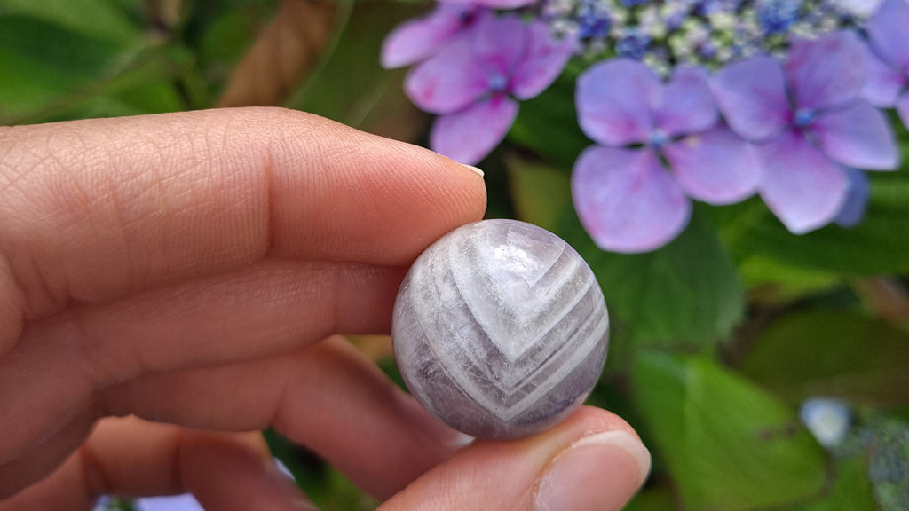 image of a dream amethyst mini sphere. This healing crystal is available at dumi's crystals