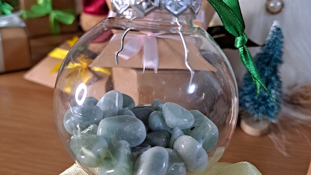 image of a christmas tree bauble filled with green aventurine chips. this Christmas decoration is available at dumi's crystals