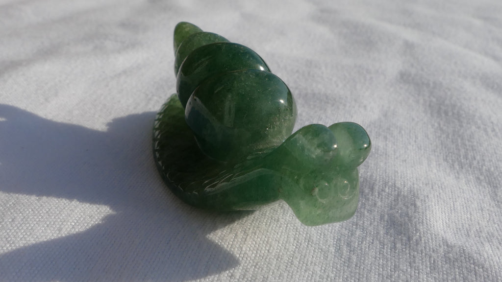 image of a green aventurine snail carving. this healing crystal is available at dumi's crystals