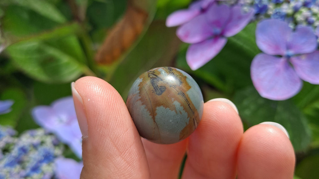 image of a polychrome jasper mini sphere. this crystal is available at dumi's crystals
