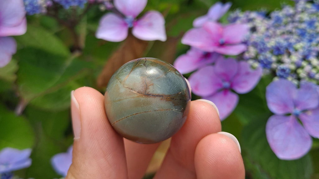 image of a polychrome jasper mini sphere. This crystal is available at dumi's crystals
