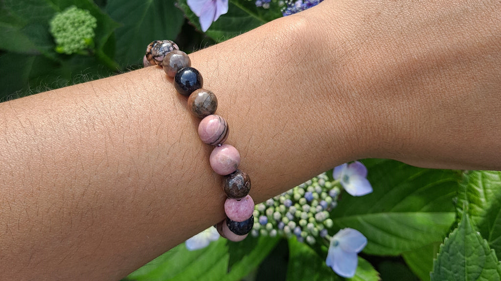 image of a rhodonite bead bracelet. this healing crystal is available at dumi's crystals