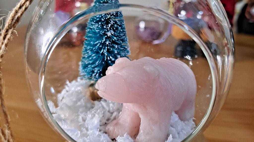 image of a rose quartz bear carving and christmas tree open bauble. this christmas decoration is available at dumi's crystals