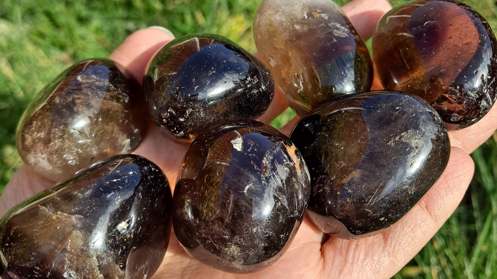 image of smoky quartz tumble stones. This healing crystal is available at dumi's crystals