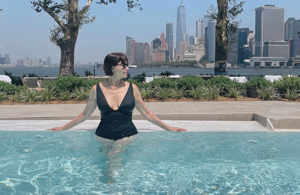 woman in black swimsuit in pool in new york city rooftop