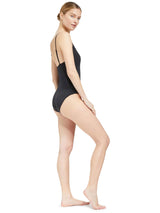 the side of Model wearing black v-neckline one piece bathing suit with adjustable back straps 
