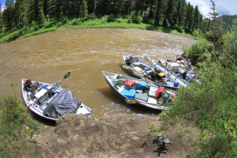 Boats are anchored on the river shore