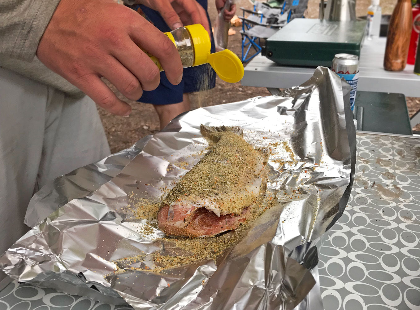 Person is seasoning a fresh caught fish