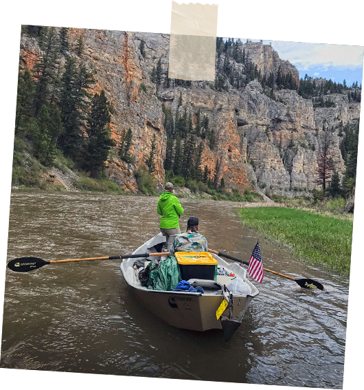 Two people in a boat fishing the river