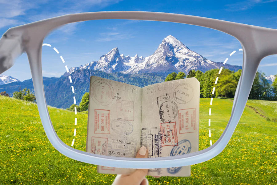 A person holding up a book in front of a pair of glasses