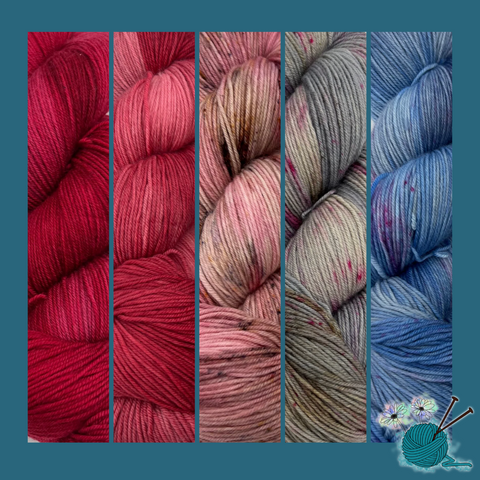 A selection of hand-dyed yarns in red, pink, grey, and blue