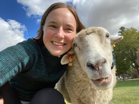 Baa-realis Fibre proprietress Jessica DeMoor posing for a selfie with a sheep