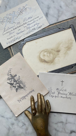 selection of antique memorial ephemera, including a post mortem photo of a woman in her casket and vintage sympathy cards