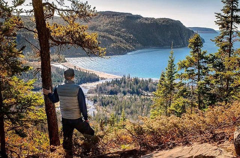 Picture of Konrad looking out to Lake Superior from a tall cliff. The view is of Old women bay on a late fall, sunny day