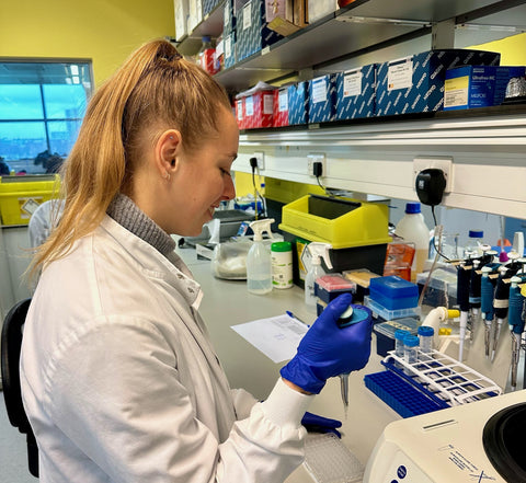 Dani Chattenton in the lab using a pipette to complete an experiment