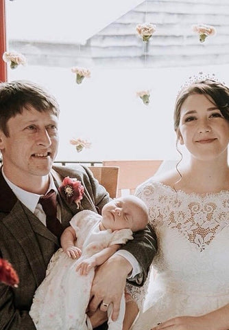 Brain Tumour Research supporter Alisha Hawke on her wedding day with newborn baby Evelyn and husband Gavin who died of an ependymoma
