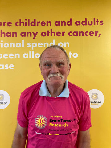 Bill Corner wearing his Brain Tumour Research t-shirt on a visit to the charity's head office